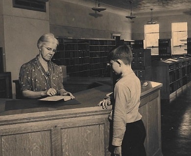 Librarian checking out a book in 1938