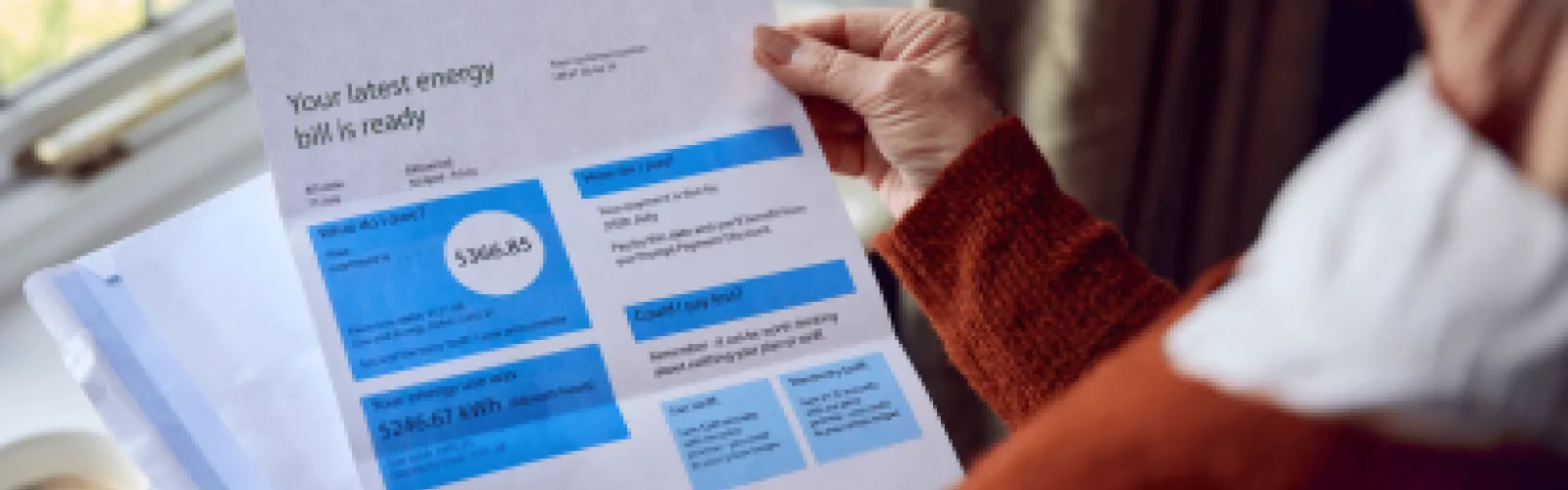Over the shoulder view of a women looking at a utility bill