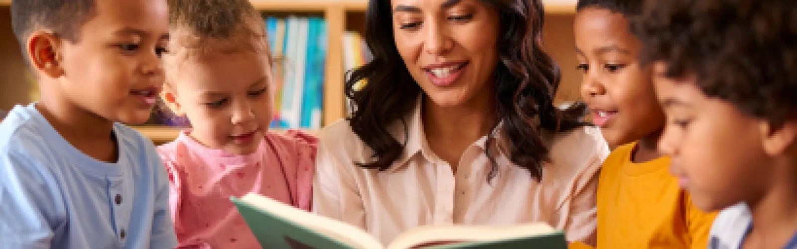 children's librarian reading to four young kids