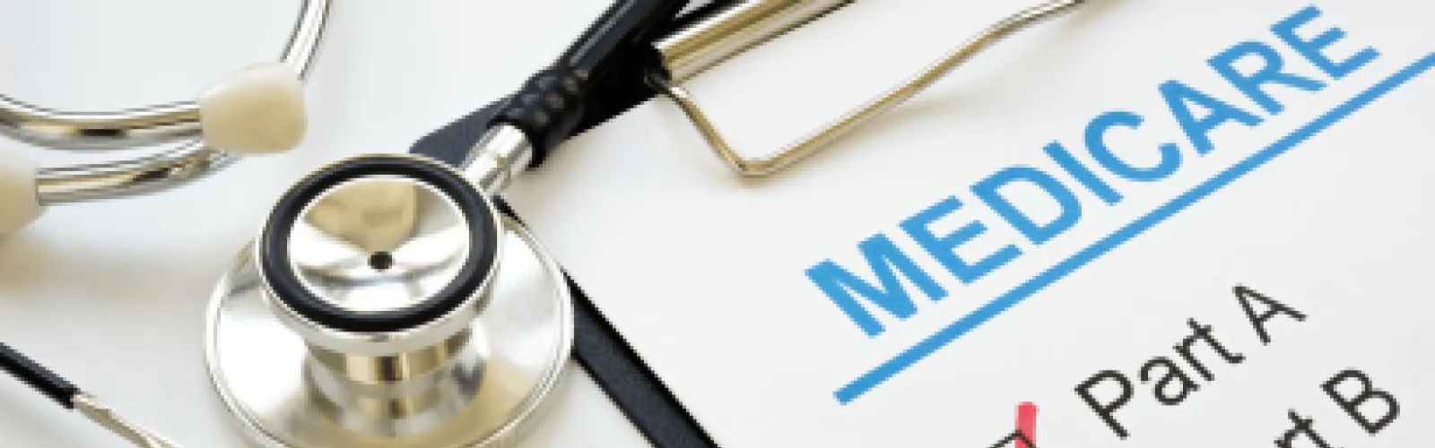 Medicare paper on a clipboard with checkmarks next to a stethoscope