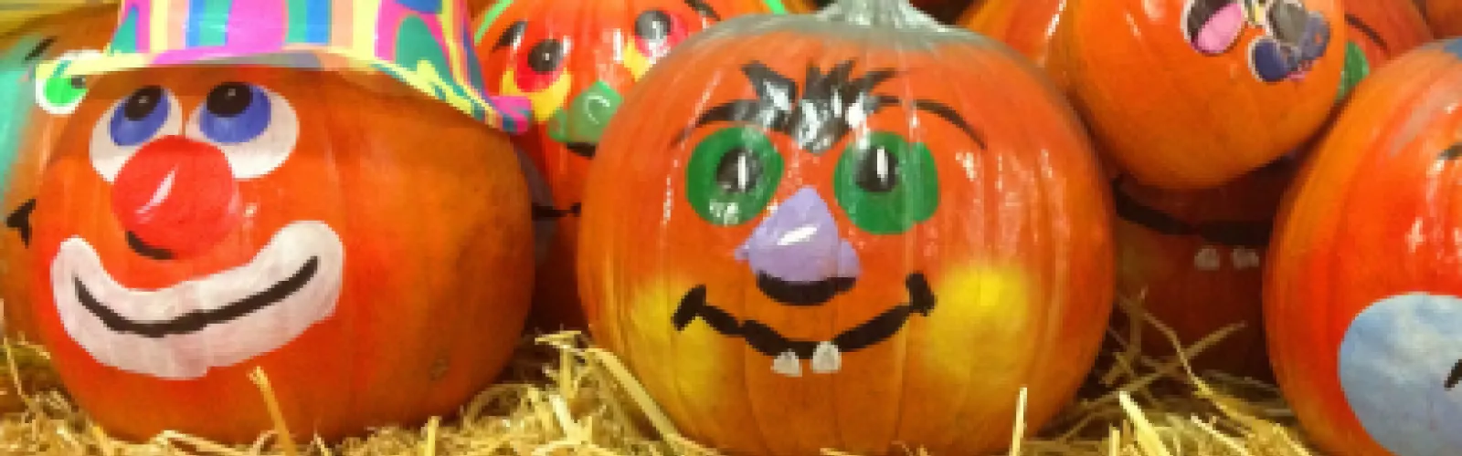 Pumpkins with colorfully painted faces